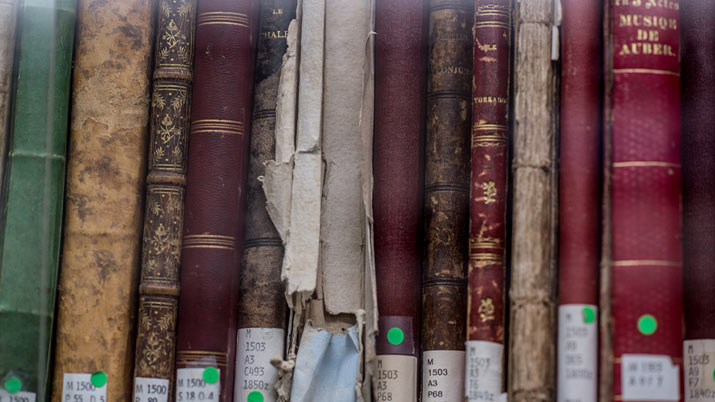 Spines of historical musicology books at the UBC School of Music